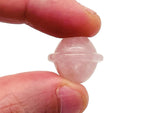 Mini rose quartz Saturn crystal carved as a planetary gemstone, 18mm, showcasing smooth pink stone and detailed ringed planet design.