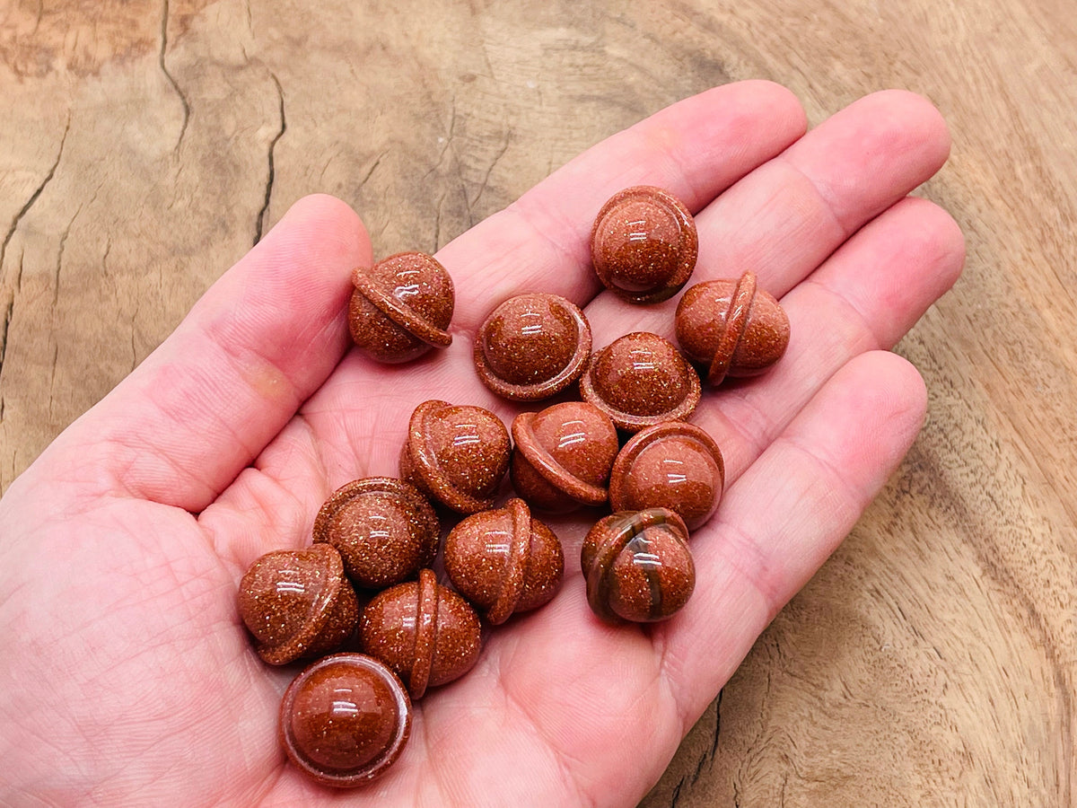 Mini 18mm Goldstone Saturn crystal carved gemstone resembling a planet, with detailed planetary rings and gold speckles.