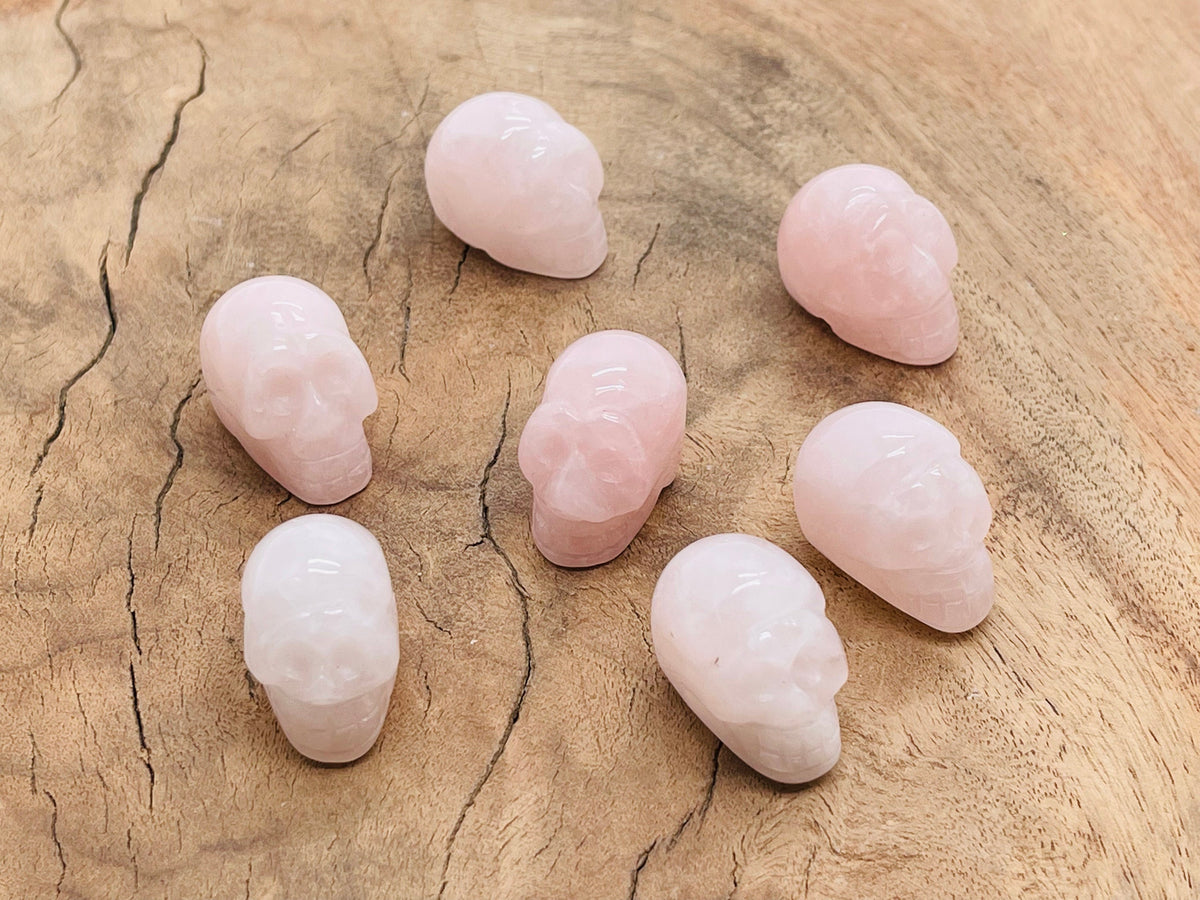 Rose quartz skull carved gemstone, 25mm, showcasing intricate details and smooth surface, from GemstoneGO.