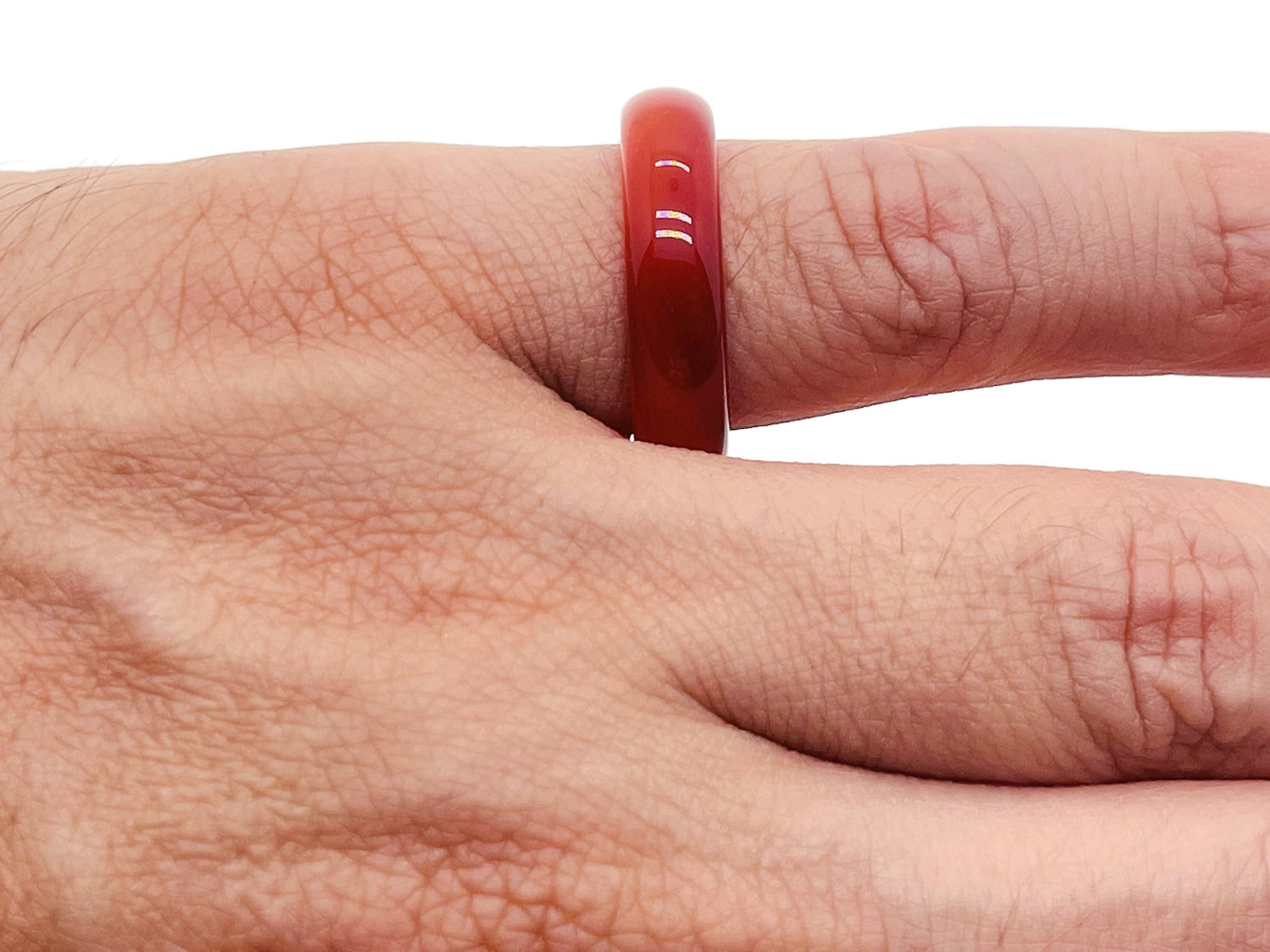 Carnelian crystal ring by GemstoneGO featuring a polished orange gemstone set in a silver band.