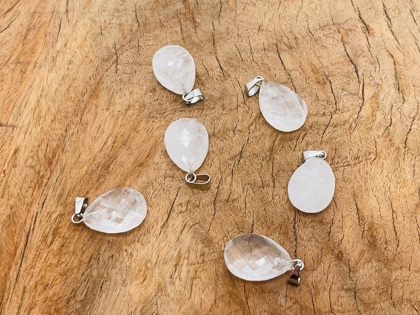 Clear quartz crystal pendant from GemstoneGO, 20mm gemstone for jewelry making, showing a polished, transparent stone with natural facets.
