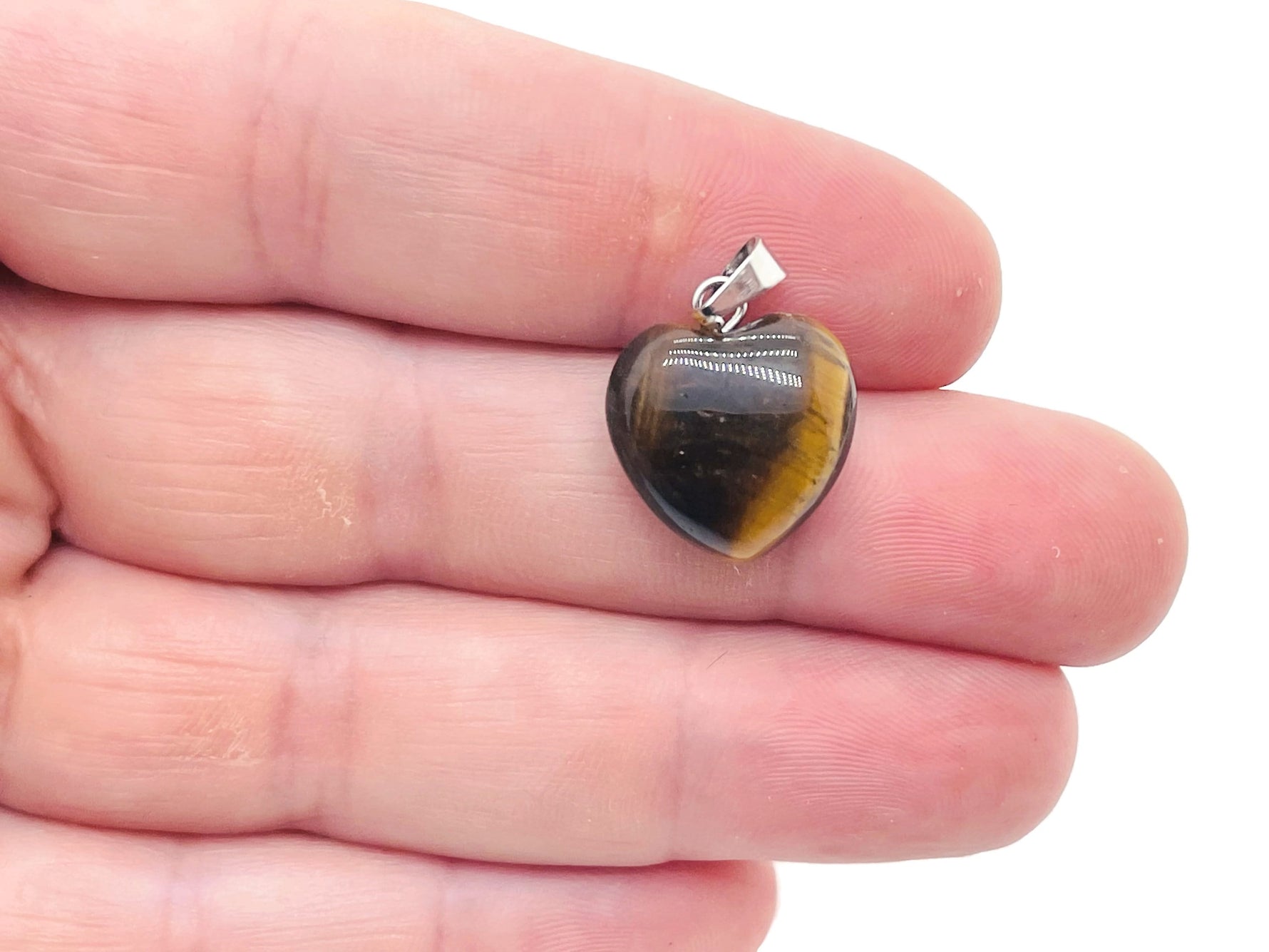 Tiger Eye heart pendant by GemstoneGO featuring a mini crystal gemstone in a polished heart shape.