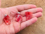 Cherry quartz crystal pendant from GemstoneGO featuring a vibrant red cherry-colored quartz gemstone with silver setting.