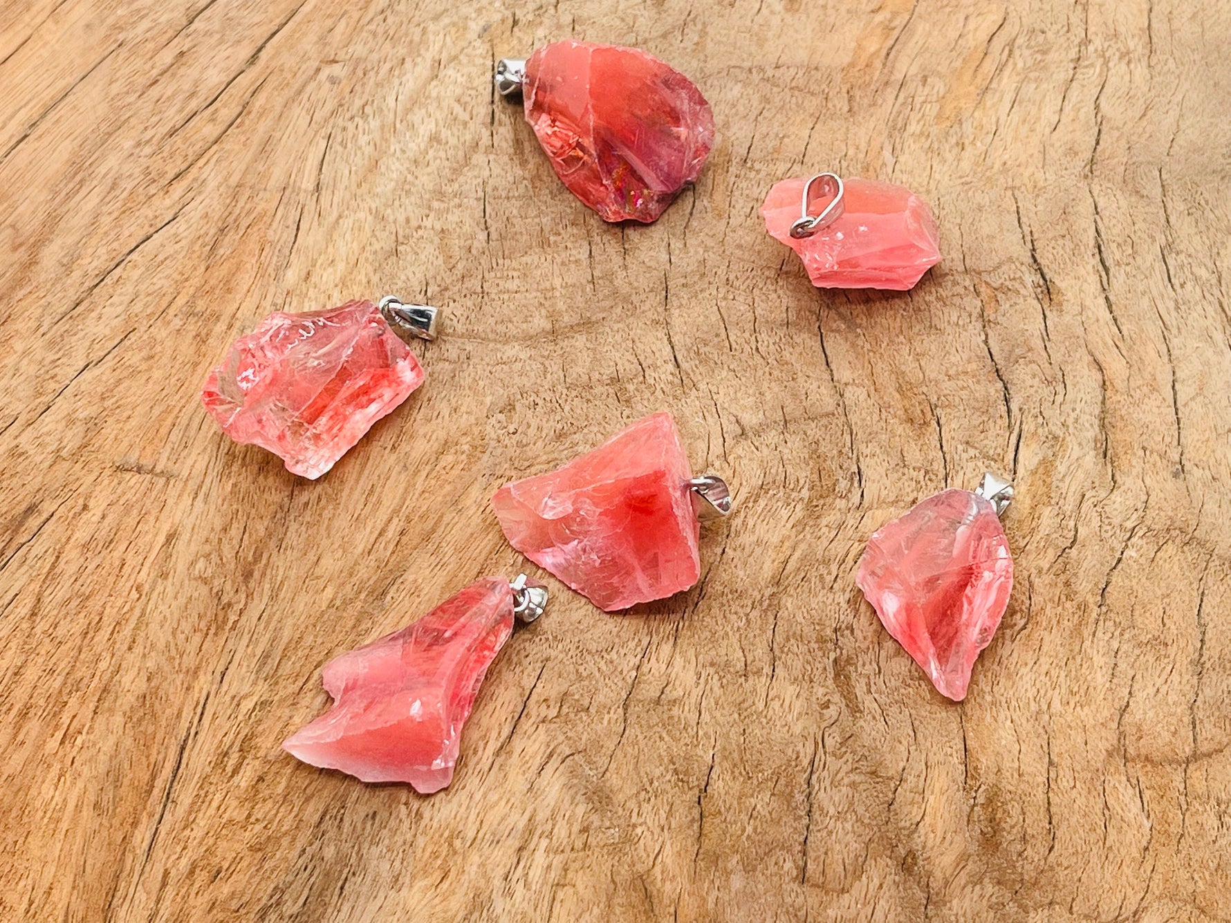 Cherry Quartz crystal pendant from GemstoneGO featuring a polished cherry-red quartz stone with a silver bail.