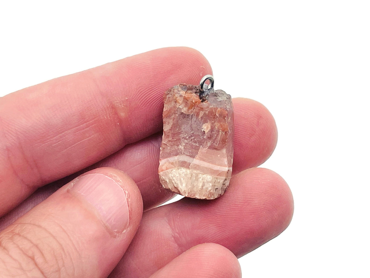 Carnelian crystal pendant from GemstoneGO featuring a polished orange-red gemstone on a silver chain.