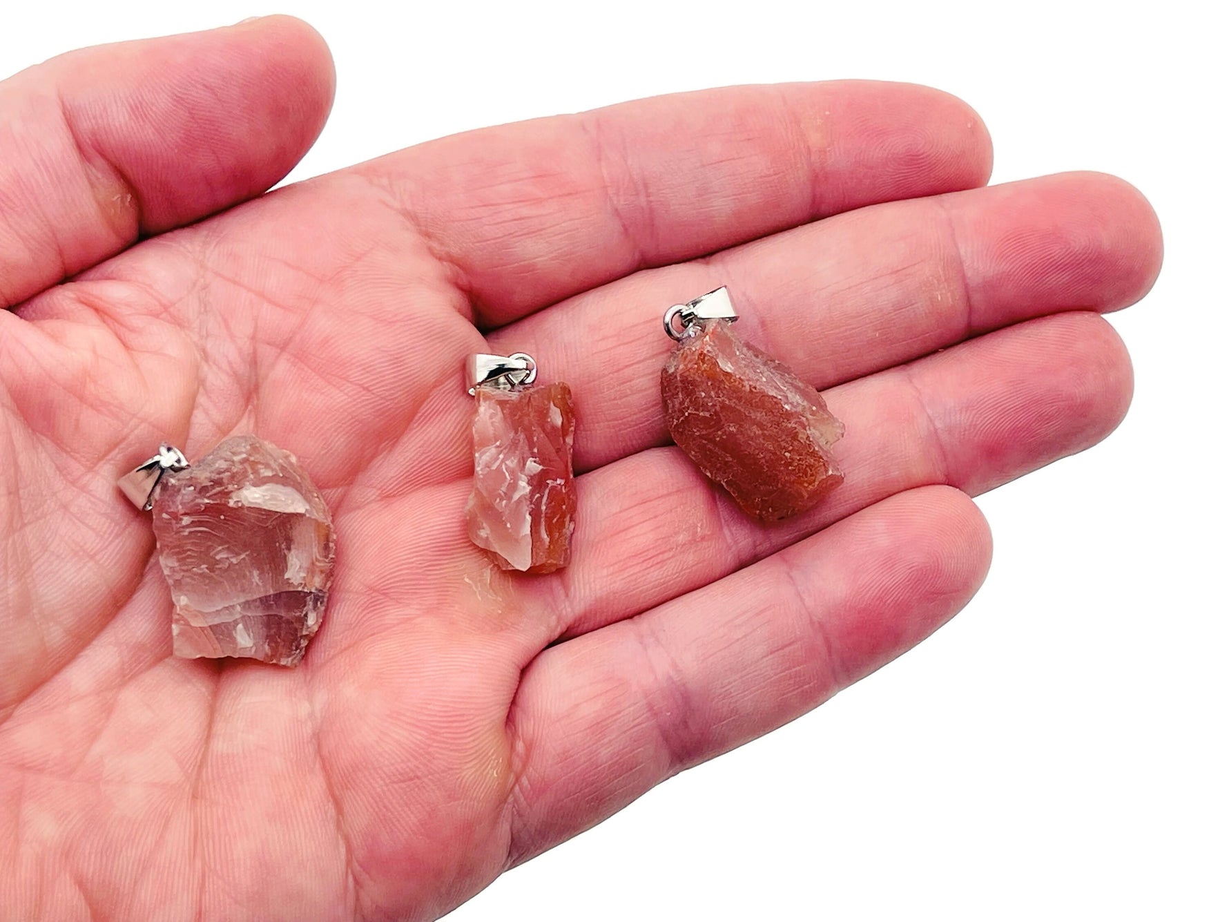 Carnelian crystal pendant from GemstoneGO featuring a polished oval-shaped orange gemstone on a silver chain.