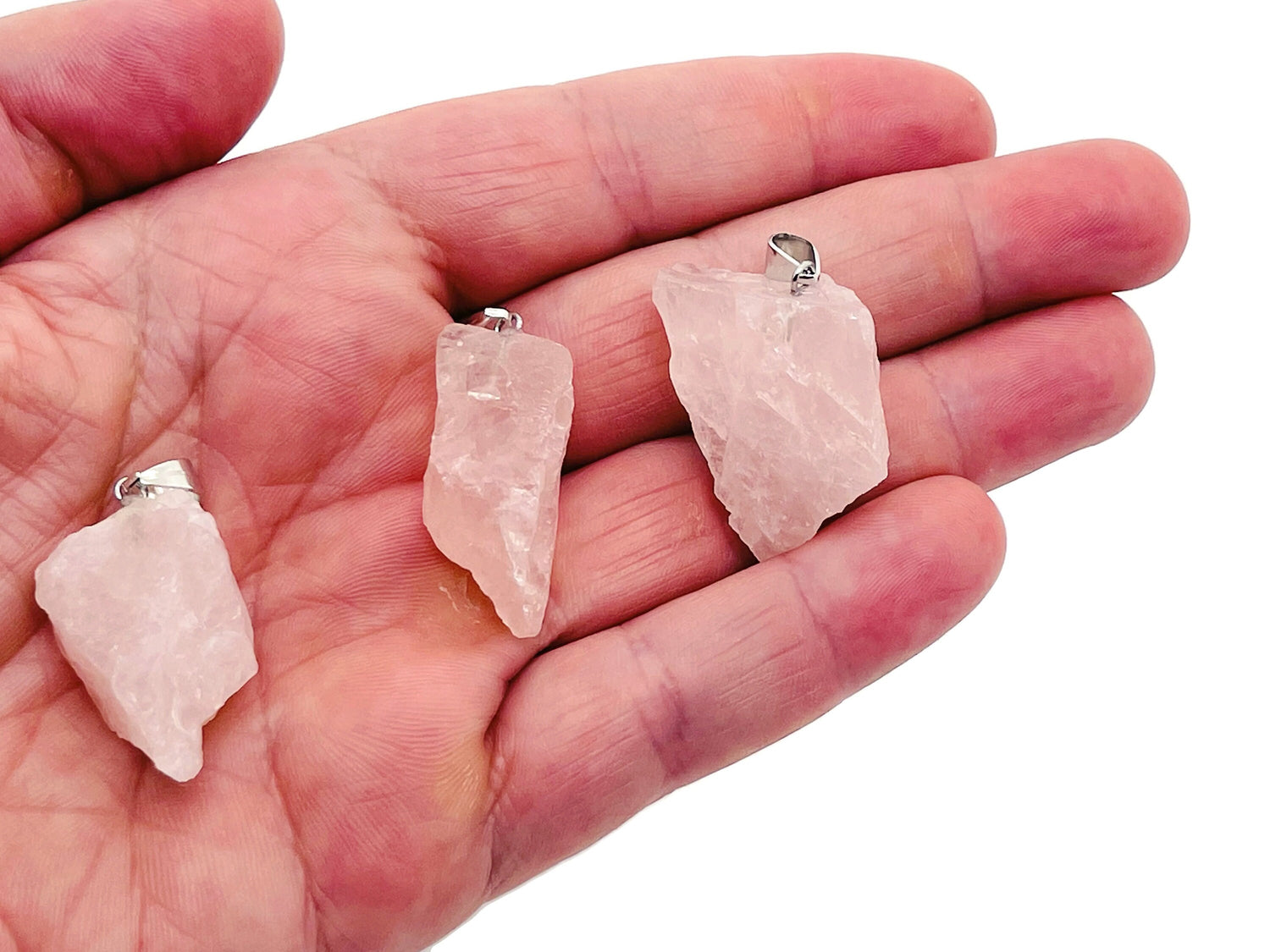 Rose Quartz crystal pendant from GemstoneGO featuring a polished heart-shaped rose quartz gemstone on a silver chain.