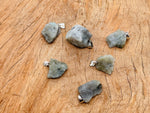 Labradorite crystal pendant from GemstoneGO featuring a polished, irregular-shaped gemstone on a silver chain.