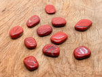 Red Jasper flat gemstone slab from GemstoneGO featuring a smooth, polished red mineral crystal with natural gemstone patterns.