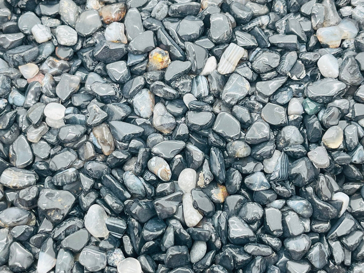 Semi-tumbled black agate crystal chips, 5-8mm gemstone stones from GemstoneGO, displayed in a bulk pack.