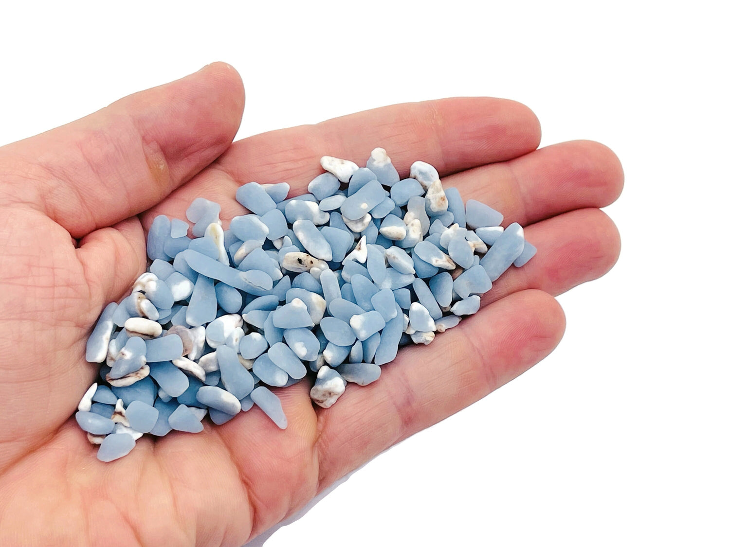 Semi-tumbled Angelite crystal chips in 5-7mm, displayed in bulk from GemstoneGO, showcasing smooth, pale blue gemstone fragments.