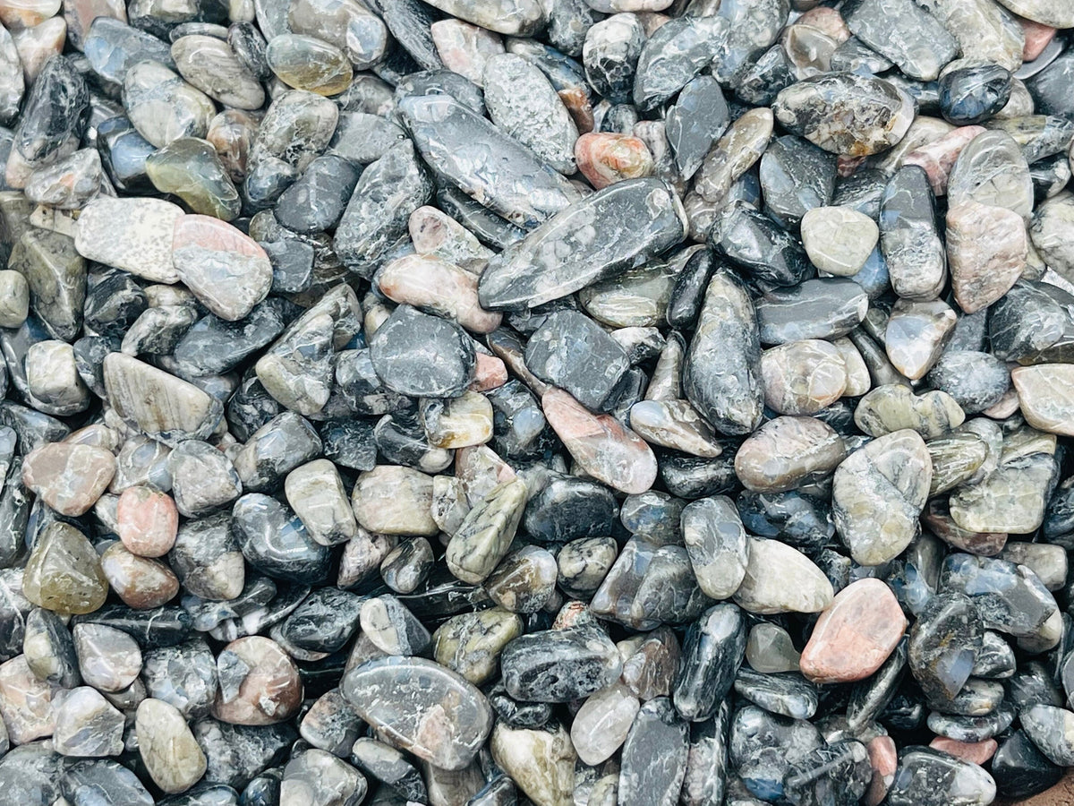 Blue Liberite Que Sera Crystal Chips from GemstoneGO, semi-tumbled 7-9mm gemstone bulk stones in a natural setting.