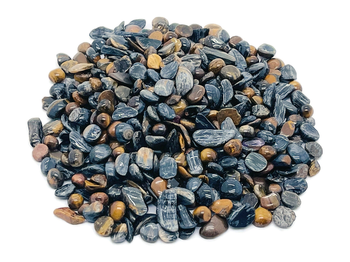 Blue Tiger Eye crystal chips from GemstoneGO, semi-tumbled 5-7mm stones, vibrant blue and golden-brown gemstone bulk lot.