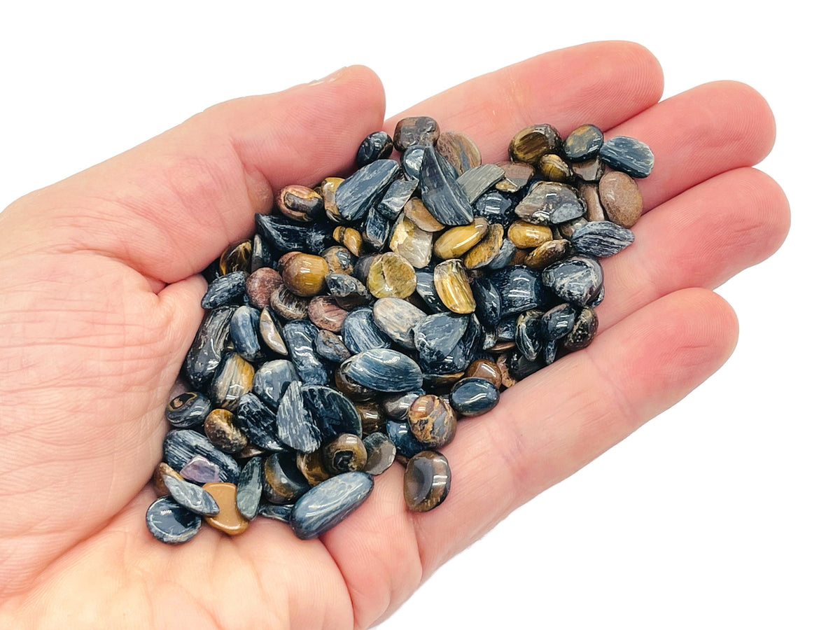 Blue tiger eye crystal chips, semi-tumbled 5-7mm gemstone from GemstoneGO, shown in close-up with vibrant blue and brown tones.