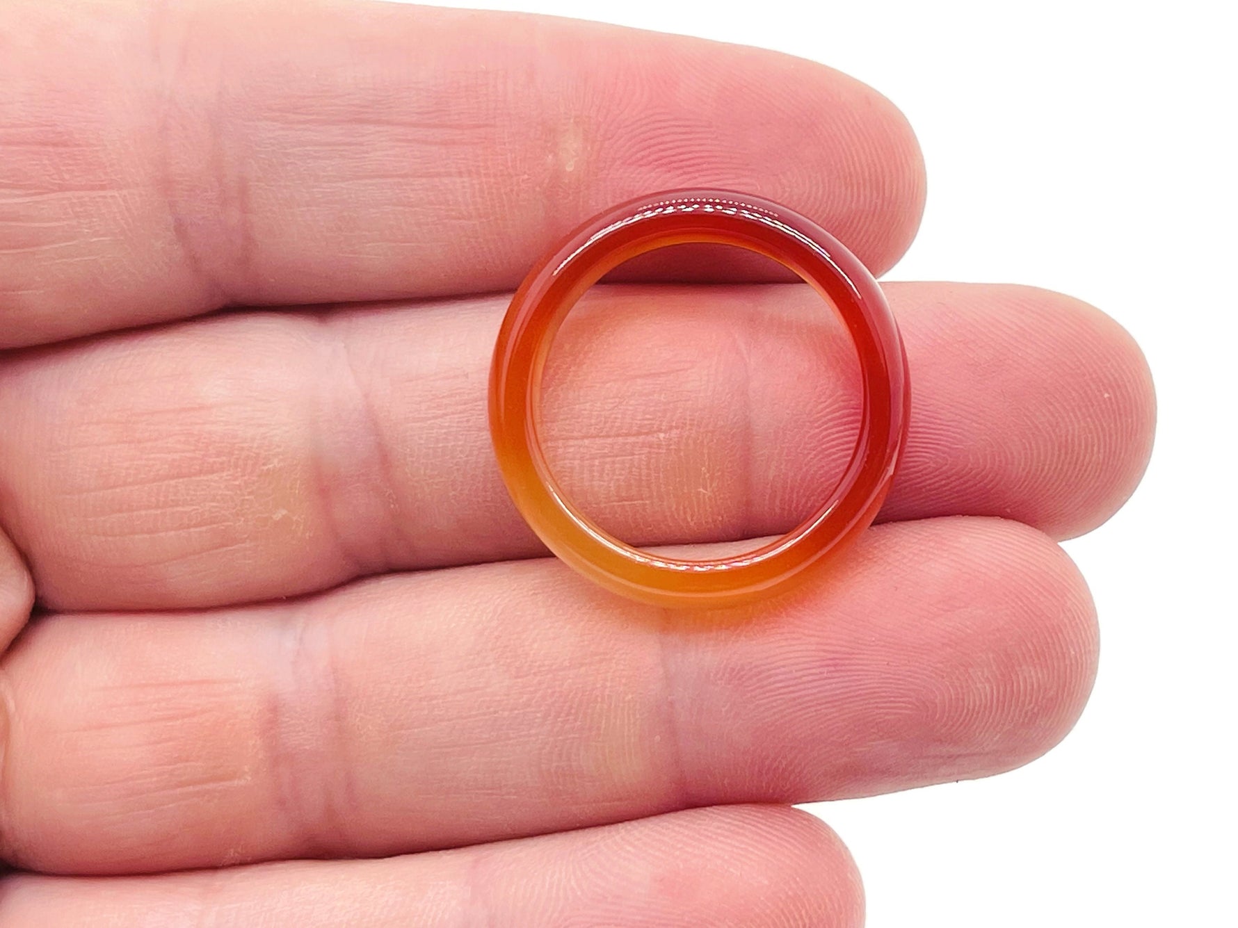 Carnelian crystal ring by GemstoneGO featuring a vibrant orange gemstone set in a silver band.