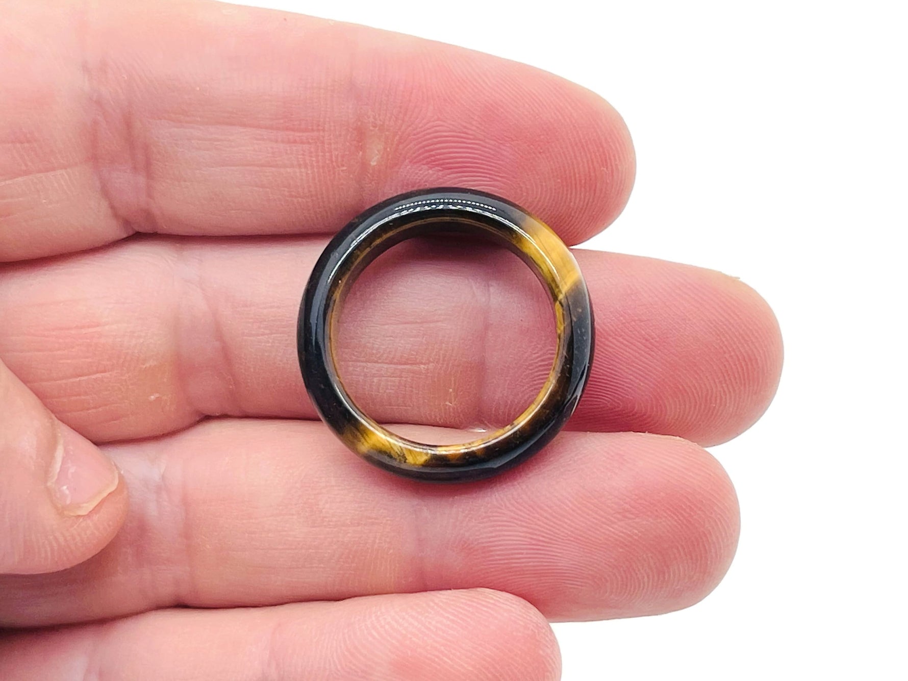 Tiger Eye crystal ring by GemstoneGO featuring a polished golden-brown gemstone set in a silver band.