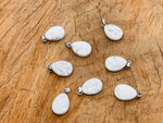 Howlite crystal pendant in a 20mm size, jewelry making supply by GemstoneGO, featuring a polished, gray and white marbled stone.