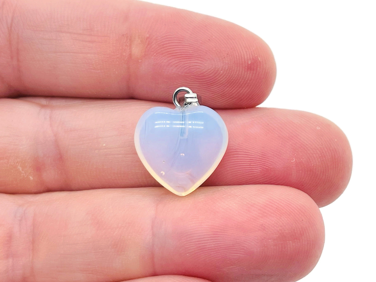 Opalite heart-shaped crystal pendant from GemstoneGO, small pendant with a smooth, polished surface and silver bail attachment.