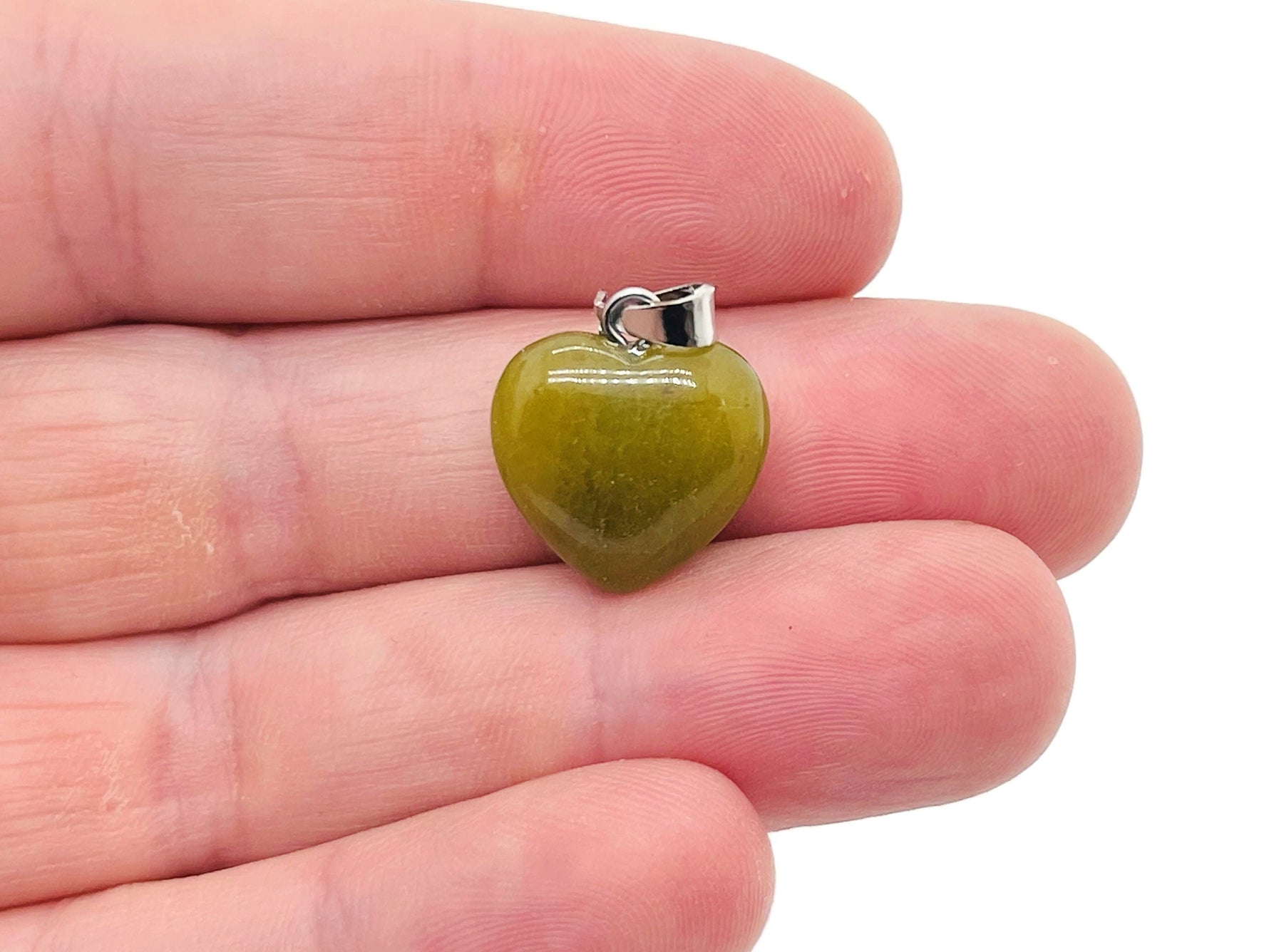 Nephrite jade heart pendant with mini crystal accent, gemstone jewelry by GemstoneGO, showing close-up of pendant on a chain.