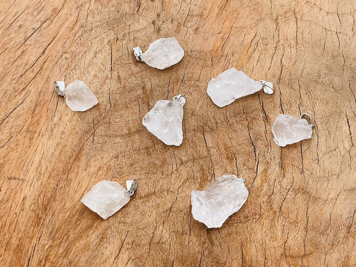 Clear quartz crystal pendant from GemstoneGO featuring a polished, natural gemstone on a silver chain.