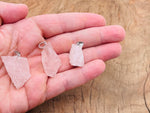 Rose quartz crystal pendant from GemstoneGO, featuring a polished pink gemstone on a delicate silver chain.