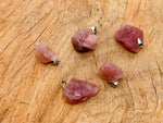 Strawberry Quartz crystal pendant from GemstoneGO featuring a polished teardrop-shaped gemstone with silver bail attachment.