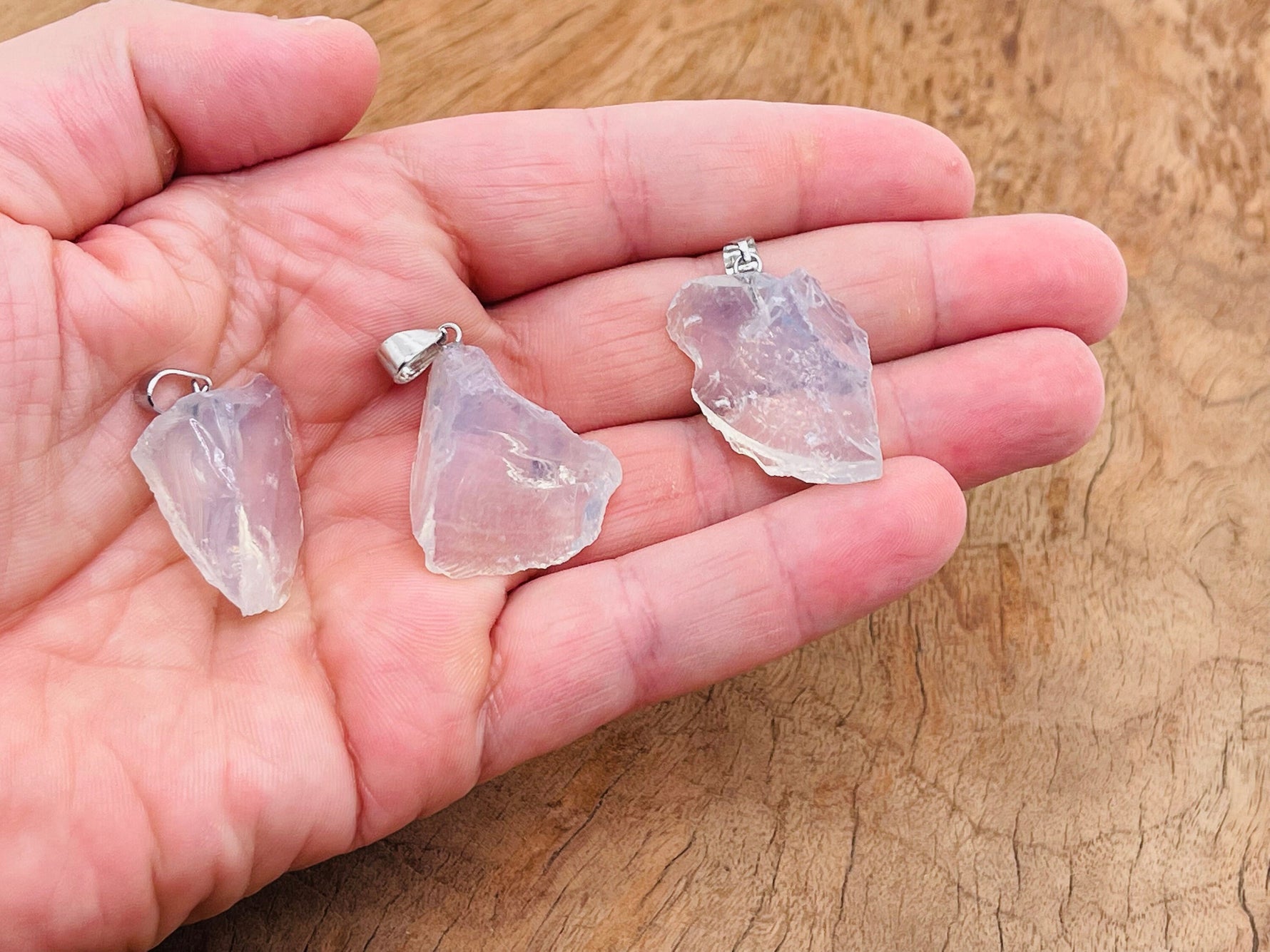 Opalite crystal pendant from GemstoneGO featuring a smooth, oval-shaped gemstone on a silver chain.