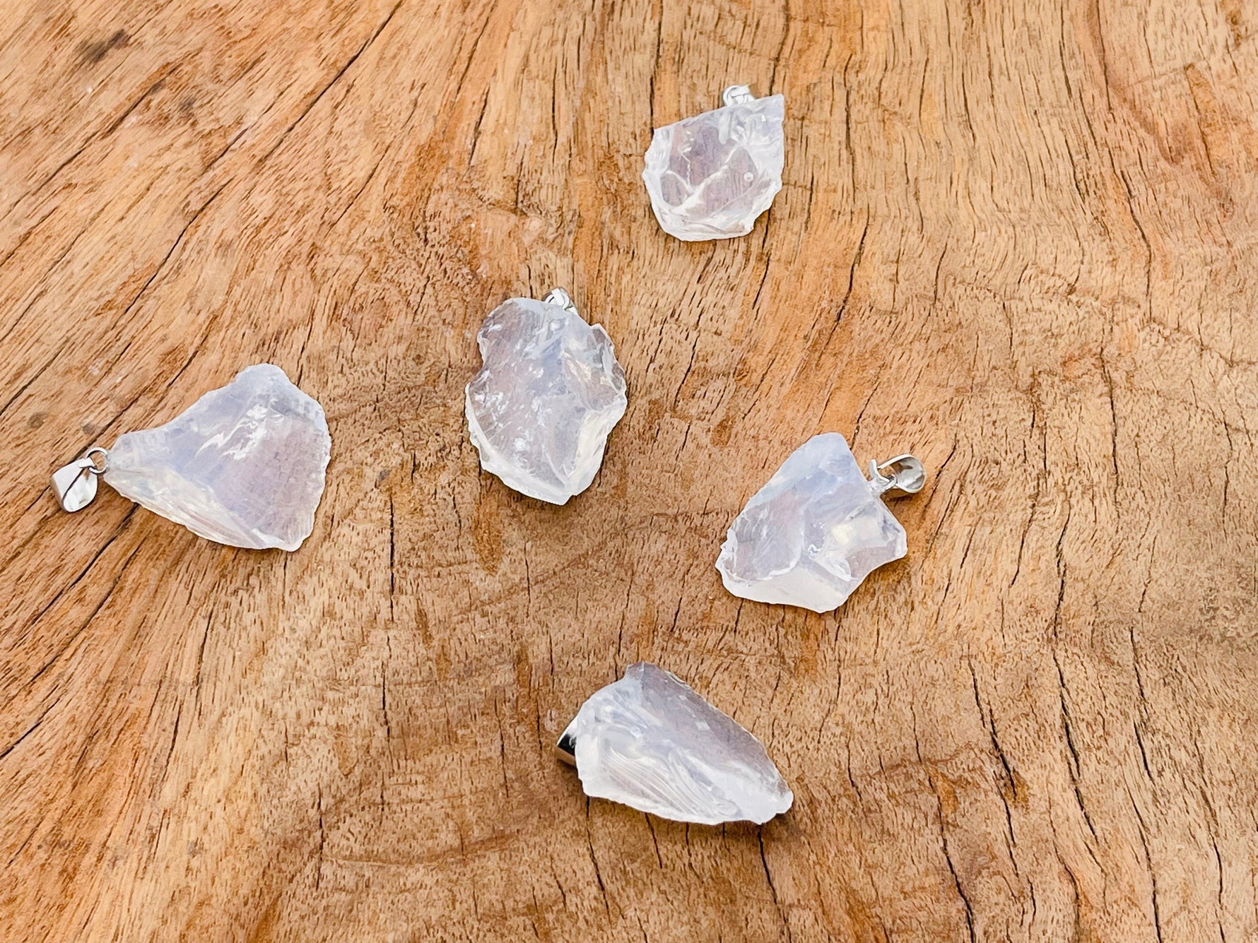 Opalite crystal pendant necklace from GemstoneGO, featuring a smooth, glowing opalite gemstone on a silver chain.