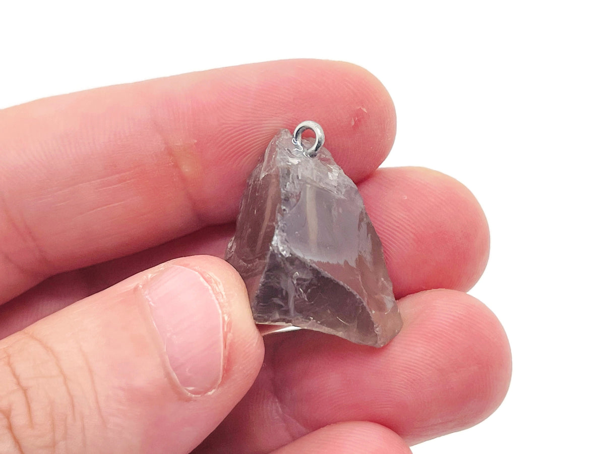 Smoky quartz crystal pendant from GemstoneGO featuring a polished, teardrop-shaped gemstone on a silver chain.