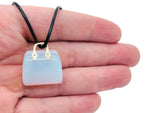 Opalite crystal purse carving gemstone pendant with intricate handbag design, showcasing a shiny, smooth surface and detailed craftsmanship.