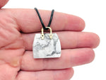 Howlite crystal purse carving gemstone pendant featuring a detailed handbag design, handmade by GemstoneGO.
