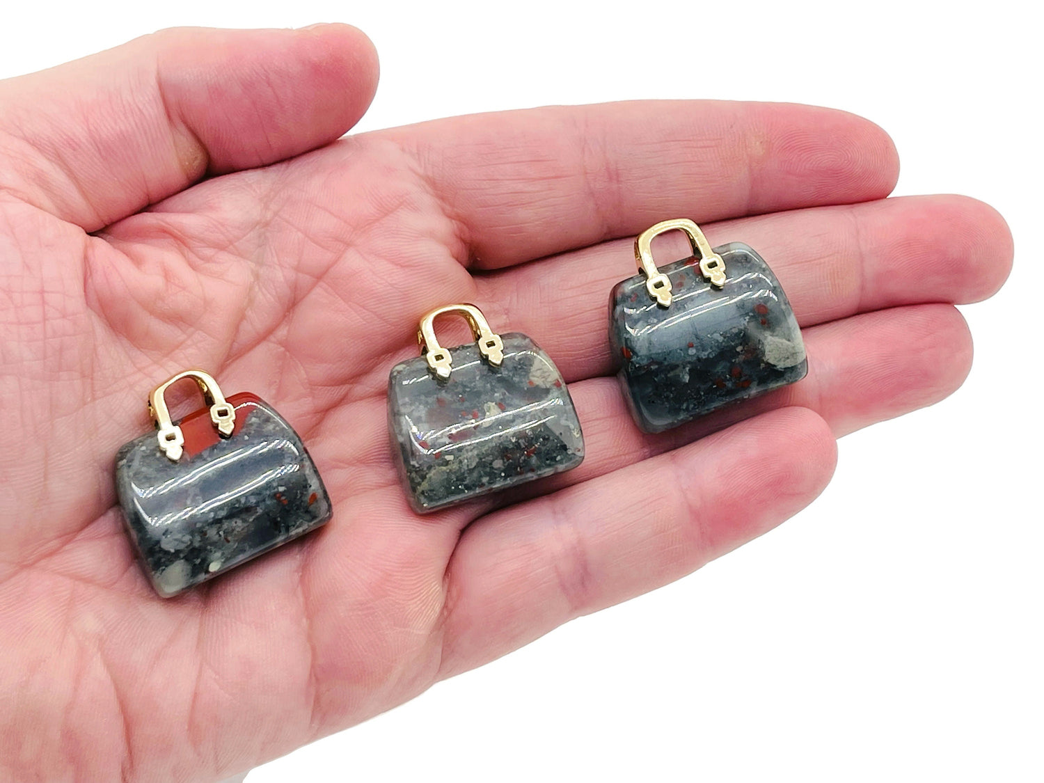 African Bloodstone crystal handbag pendant with carved gemstone design, featuring a unique bloodstone gemstone for jewelry or decor.
