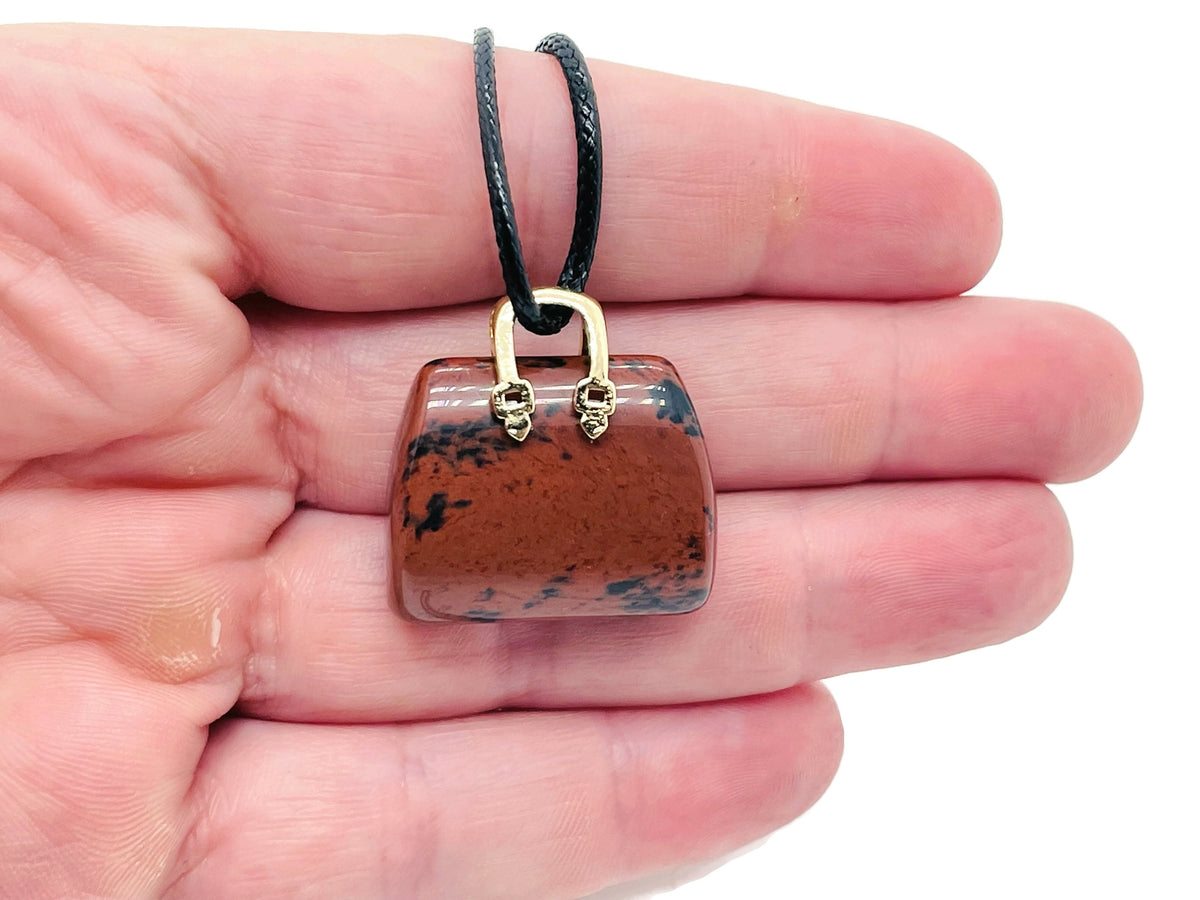 Mahogany Obsidian crystal purse carving gemstone pendant featuring a detailed handbag design, handcrafted by GemstoneGO.