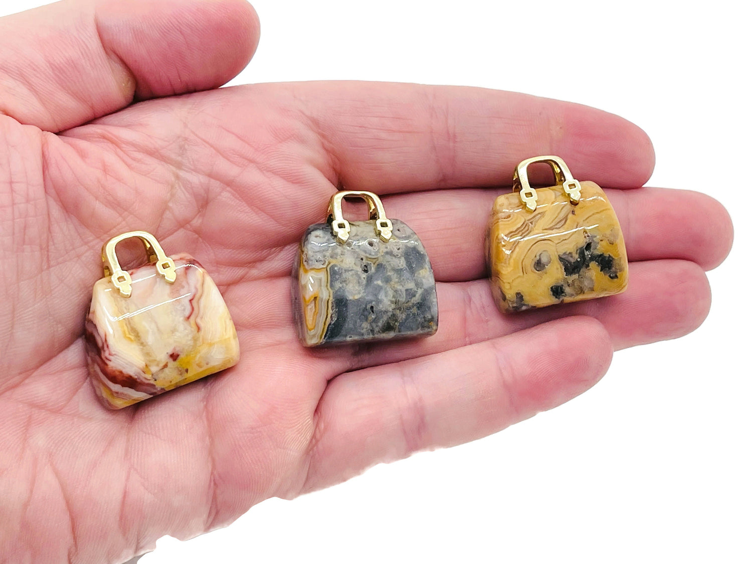 Crazy Lace Agate crystal purse carving gemstone pendant with intricate lace patterns, handcrafted by GemstoneGO.