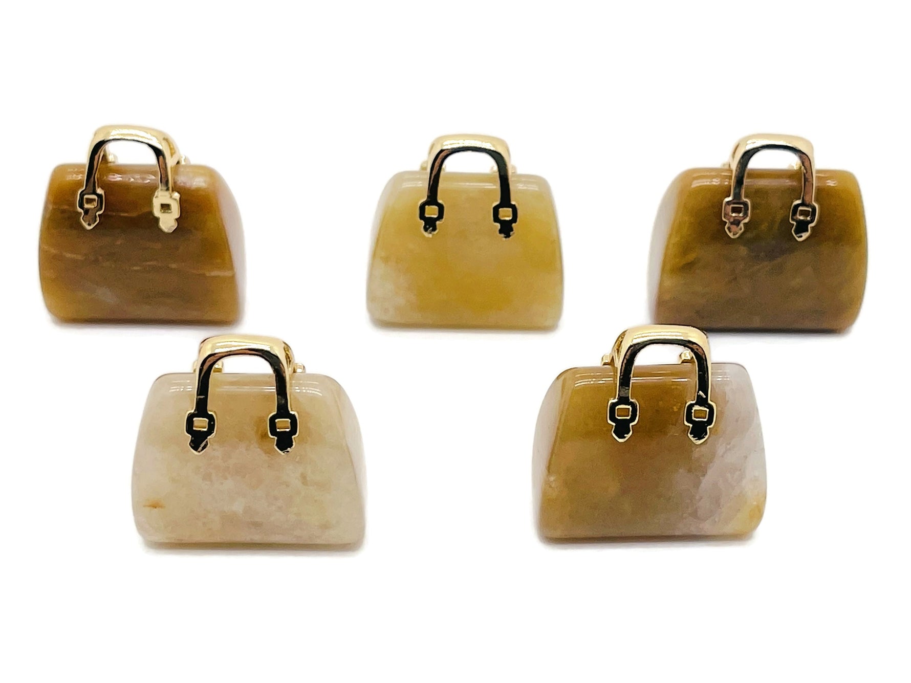 Yellow Jade crystal gemstone carved into a handbag pendant, showcasing intricate detailing and vibrant color.