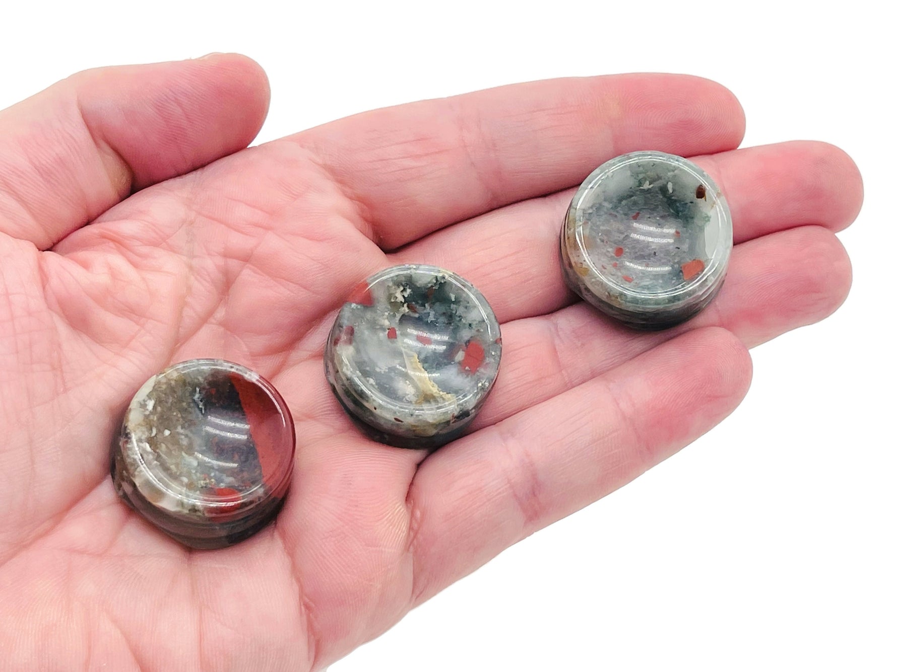 African Bloodstone crystal sphere on carved gemstone stand, showcasing deep green and red hues, perfect for home decor.