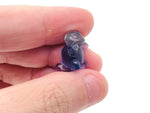 Fluorite tortoise gemstone carving by GemstoneGO, detailed multicolored stone sculpture of a tortoise on a white background