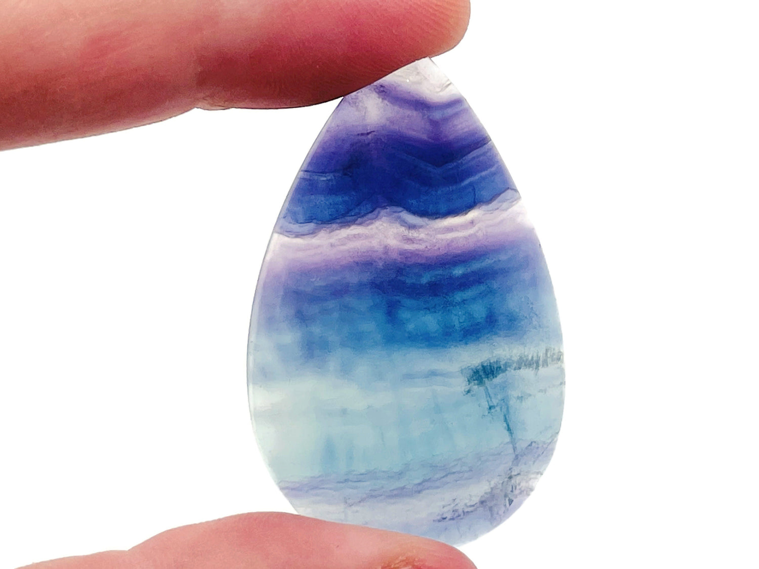 Polished fluorite crystal carving gemstone from GemstoneGO, showcasing vibrant purple and green hues with smooth, detailed craftsmanship.