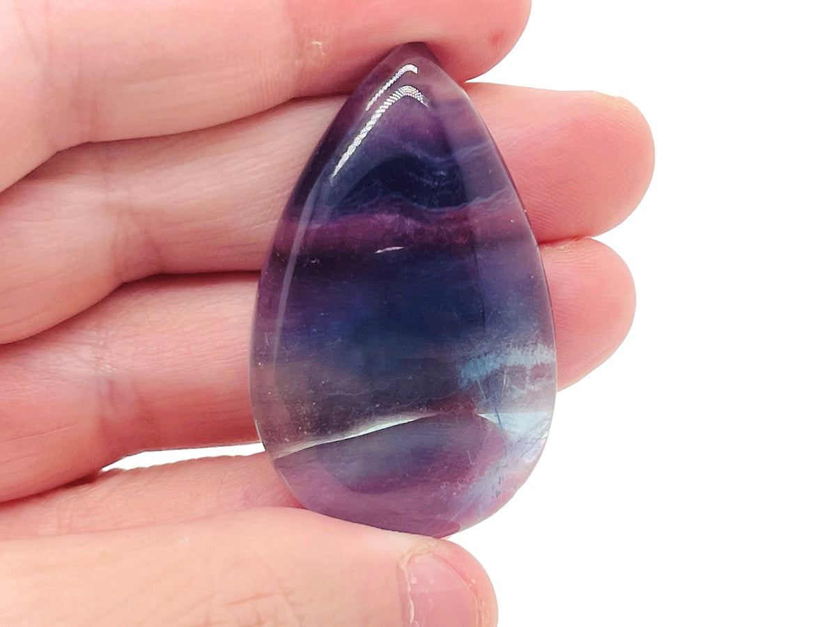 Bright green fluorite crystal carving gemstone with smooth polished surface, showcasing natural color variations and intricate craftsmanship.