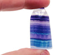 Fluorite flat tower carving gemstone from GemstoneGO, showcasing vibrant purple and green hues with smooth polished surfaces.
