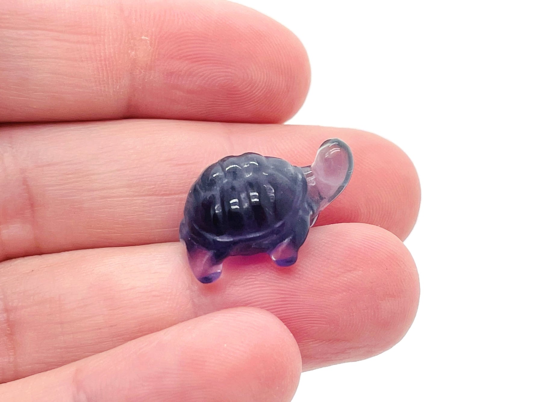 Mini fluorite turtle gemstone carving by GemstoneGO, detailed purple and green fluorite turtle sculpture on a neutral background.
