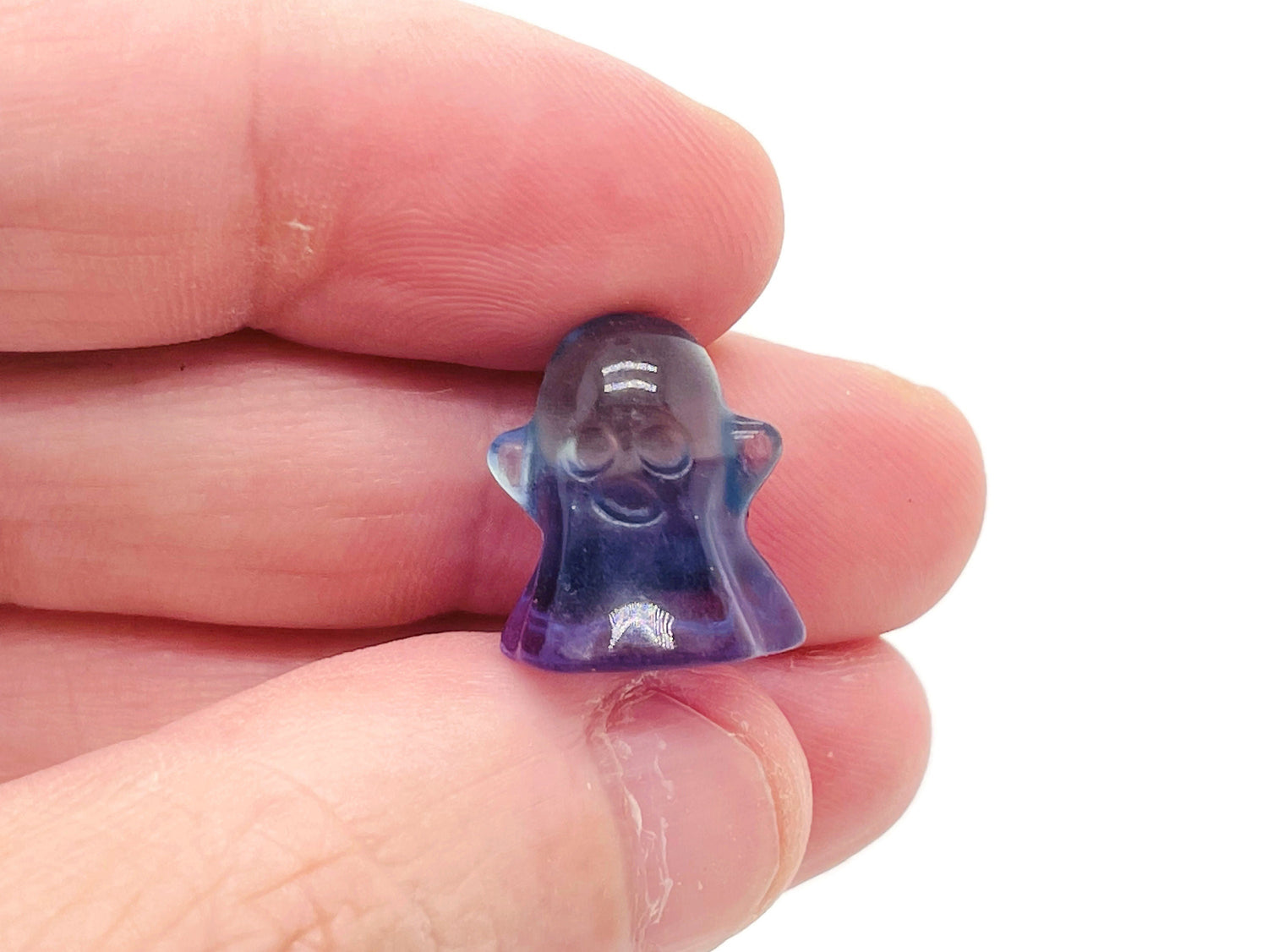 Mini fluorite ghost gemstone carving showcasing vibrant purple, green, and blue hues, crafted by GemstoneGO.