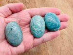 Amazonite palm gemstone spa stone from GemstoneGO, smooth and polished for massage and relaxation.