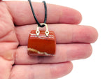 Red Jasper crystal purse carving gemstone pendant with detailed handbag design, showcasing vibrant red color and intricate craftsmanship.