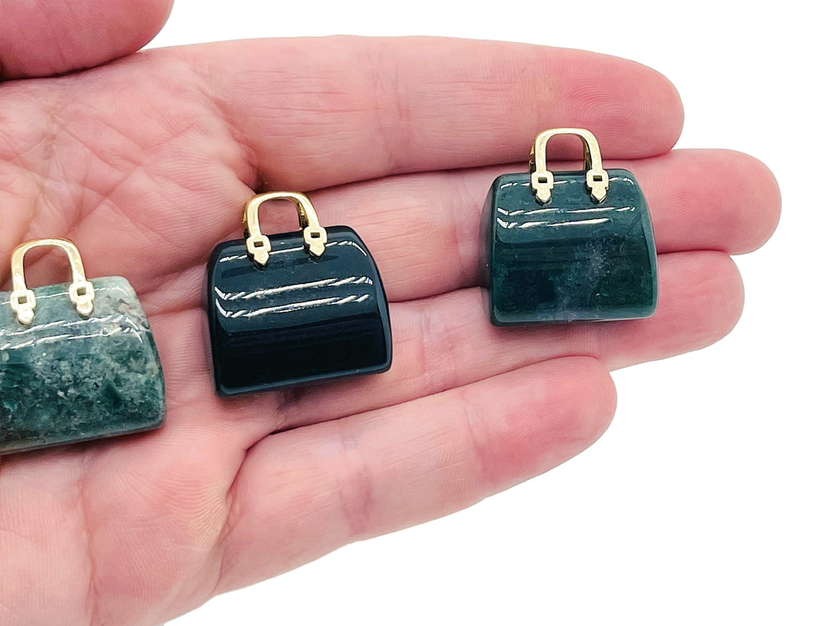 Moss agate crystal purse carving gemstone pendant with intricate details, featuring natural green and brown patterns, designed as a handbag.