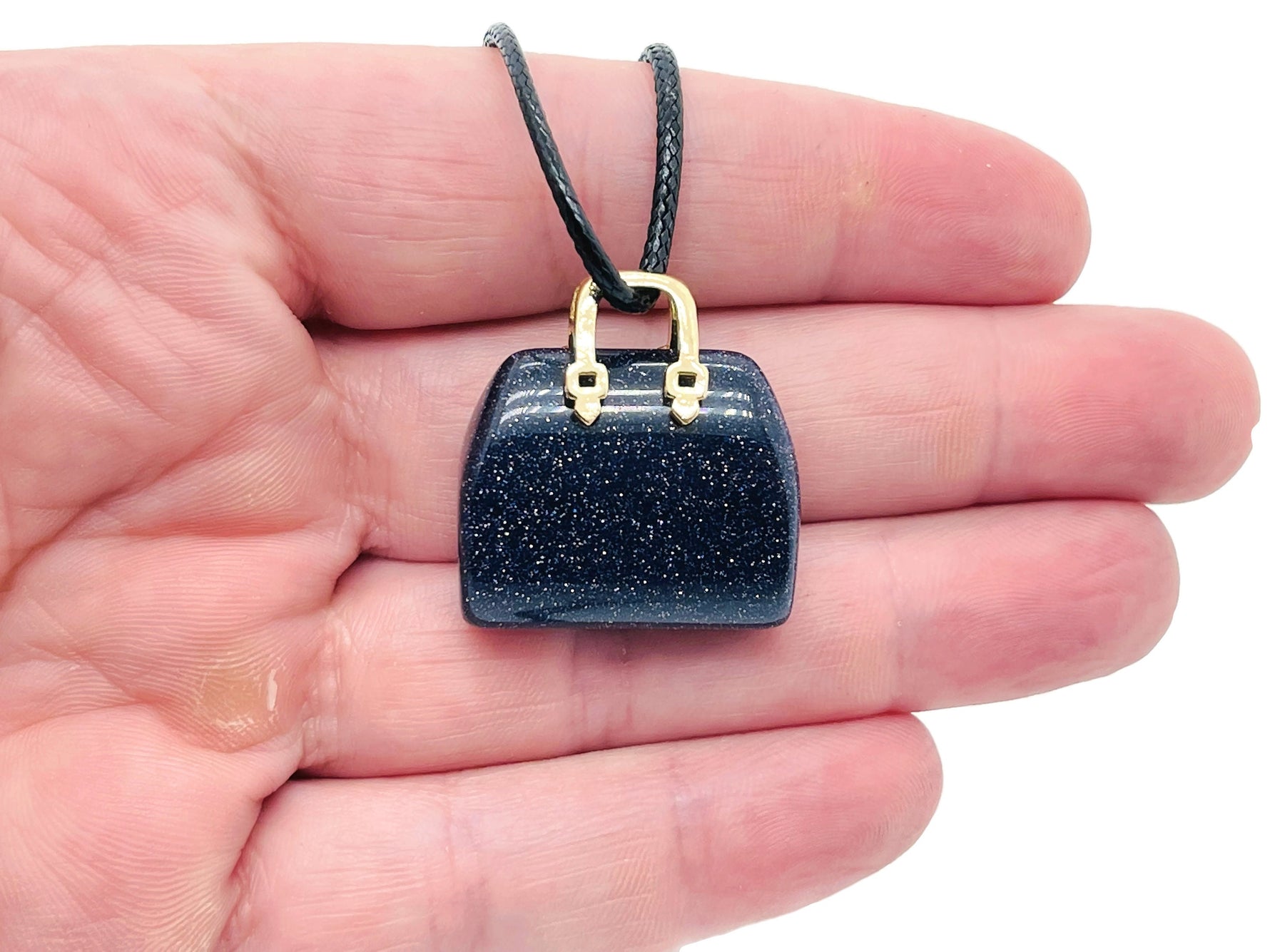 Blue Goldstone crystal handbag pendant with intricate carving, showcasing a sparkling gemstone purse charm from GemstoneGO.