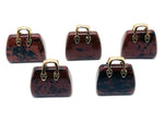 Mahogany Obsidian crystal handbag pendant carved as a purse, featuring natural gemstone details and a polished finish.
