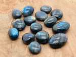 Labradorite palm gemstone spa stone by GemstoneGO, smooth polished gemstone with iridescent blue and green hues for relaxation.