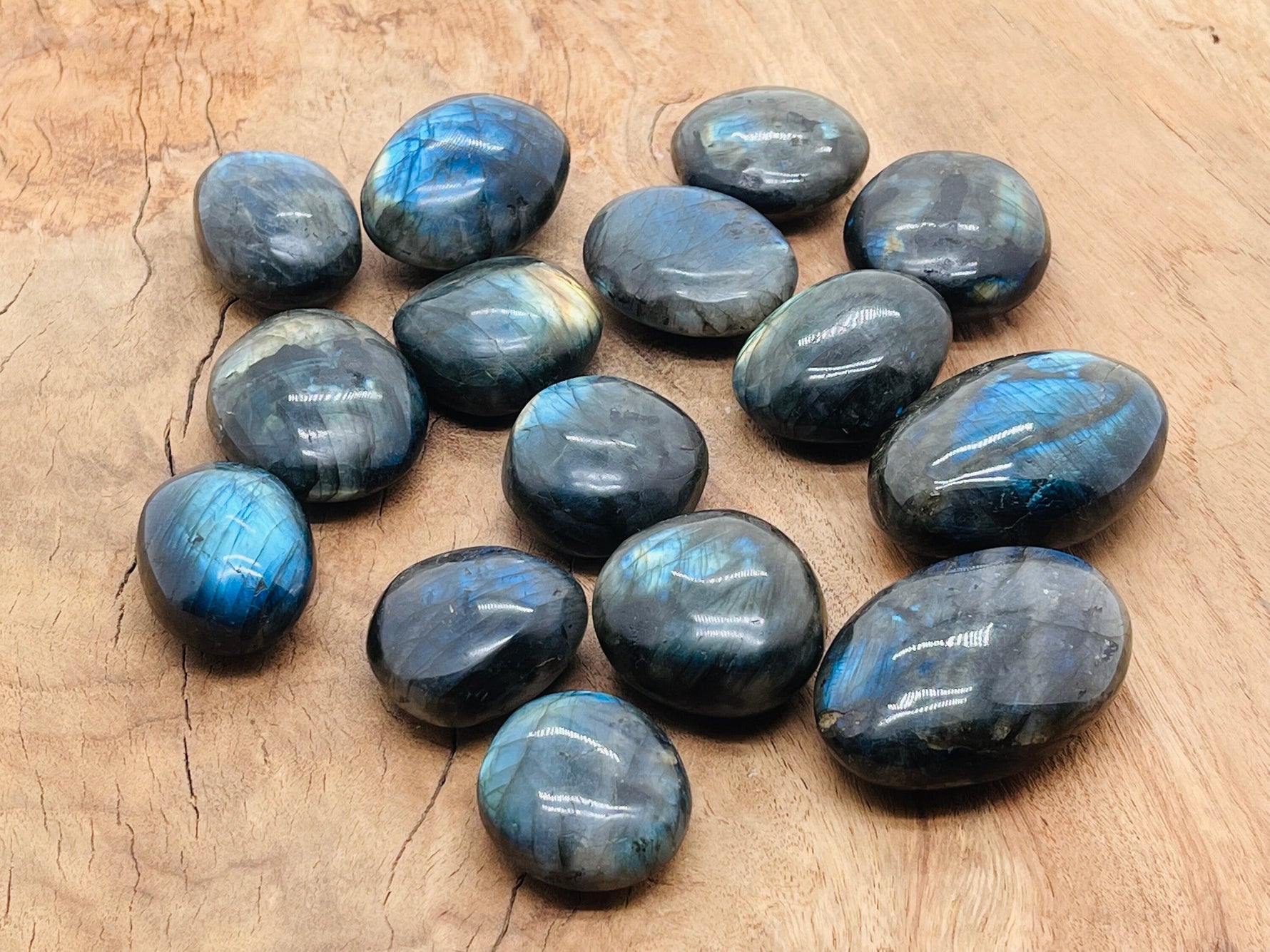 Labradorite palm gemstone spa stone by GemstoneGO, smooth polished gemstone with iridescent blue and green hues for relaxation.