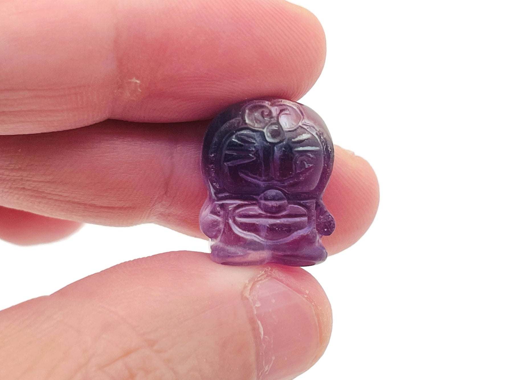 Fluorite cat carving gemstone from GemstoneGO, showing a vibrant multicolored feline sculpture with polished surface and detailed features.
